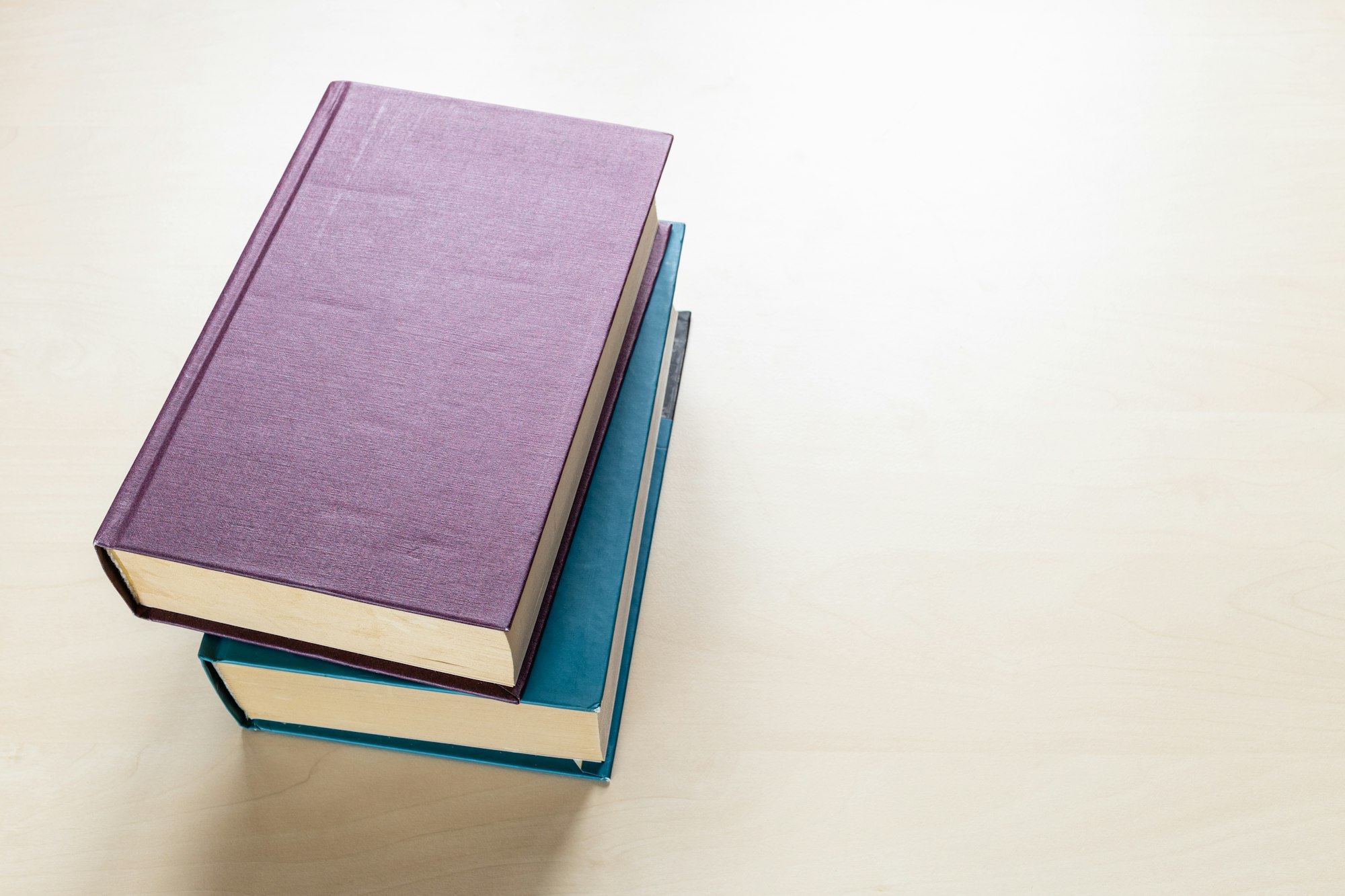 two thick volumes of books on light board