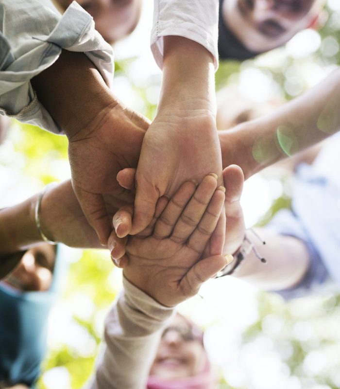 Group of diverse youth hands joined