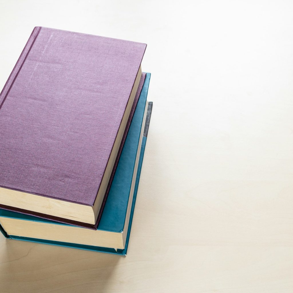two thick volumes of books on light board